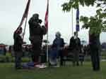 Betty Amlin places a rose at the foot of the statue moments after it has been unveiled.